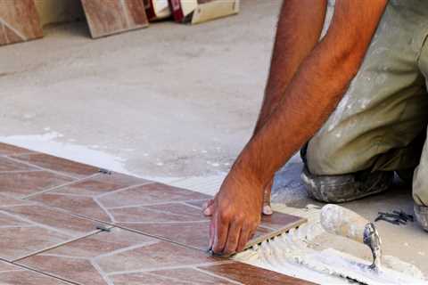 What is the first step in installing tile flooring?